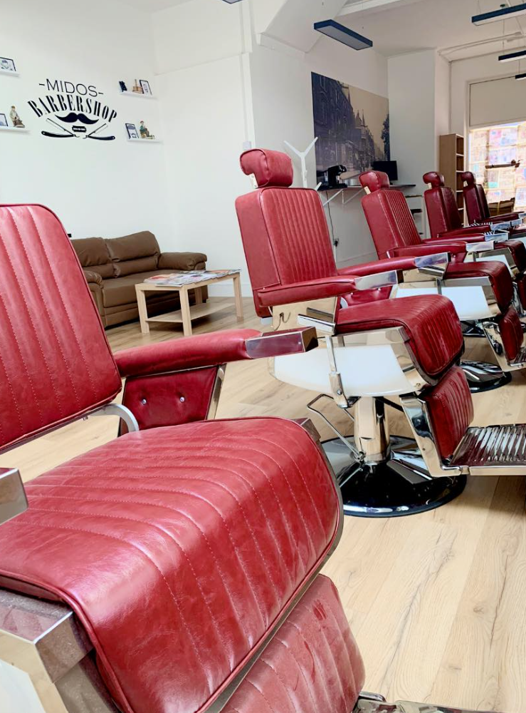 Red barber chairs from a side angle